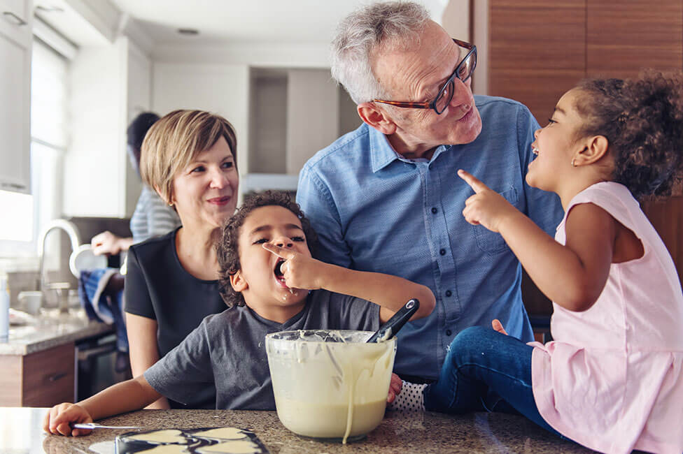 caucasian grandparents baking with their grandchildren